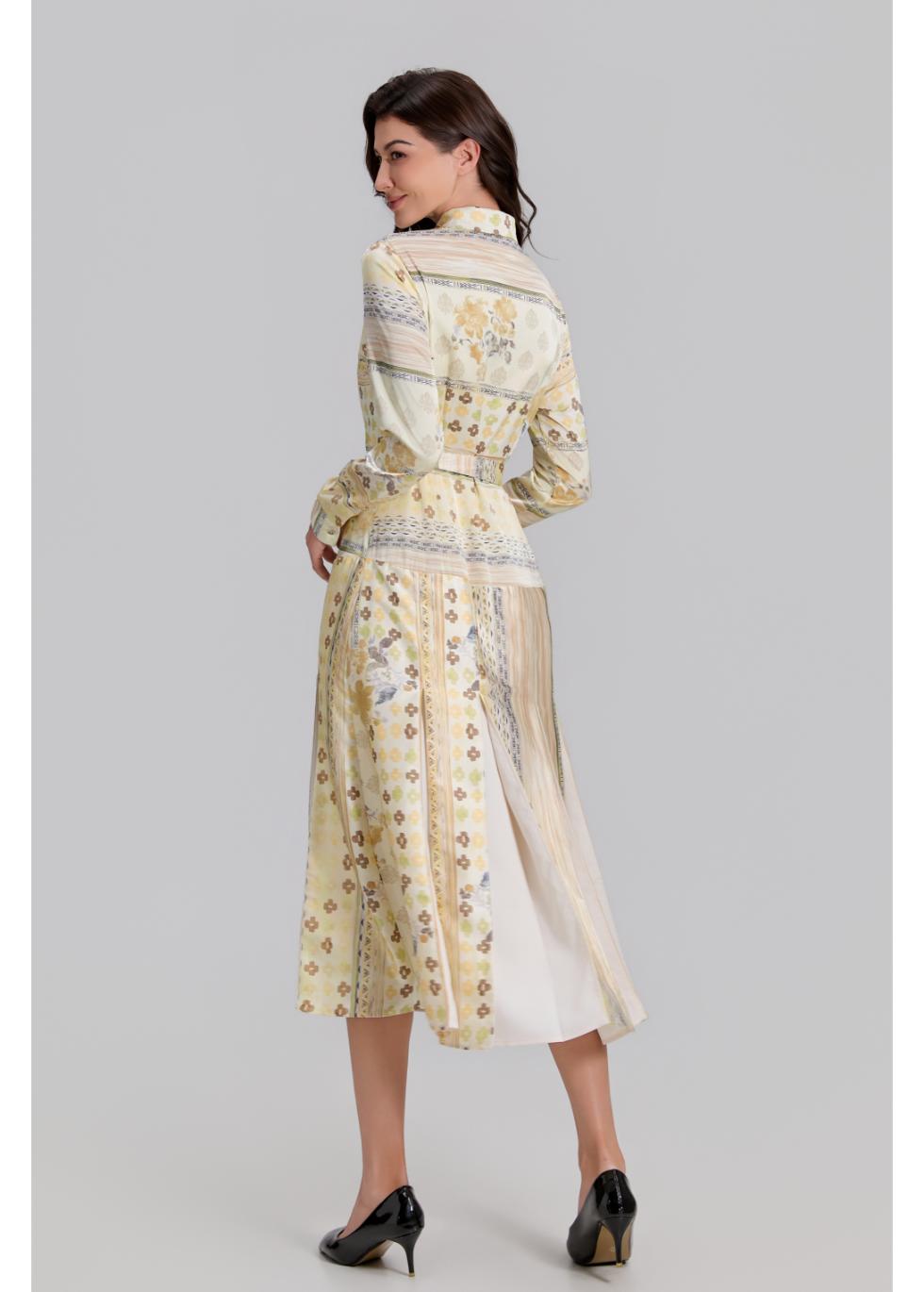 Golden Meadow pleated midi dress by MissFinchNYC featuring flowing fabric and elegant design, shown on a model.