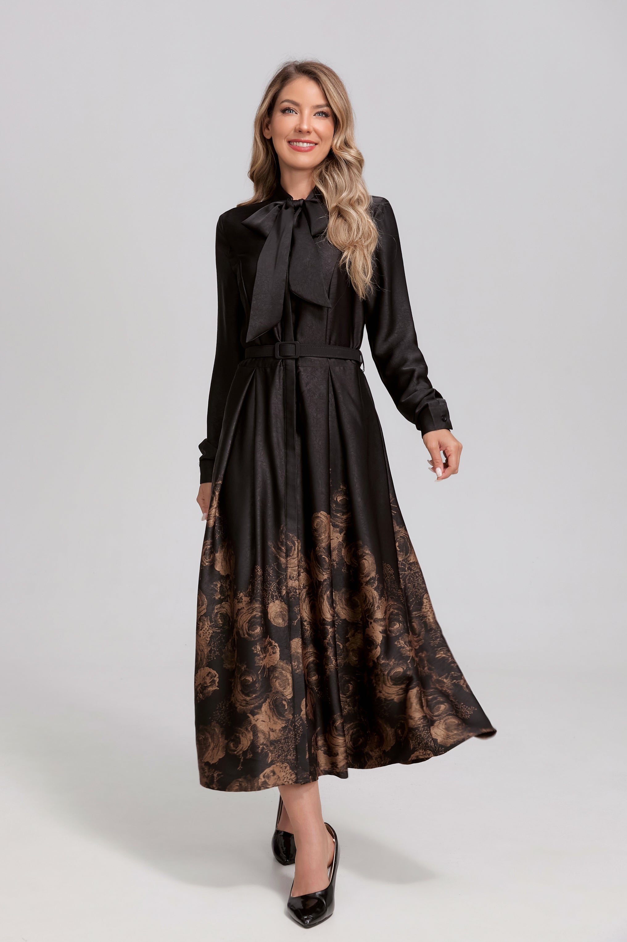 Black noir Rosewood tie-neck midi dress by MissFinchNYC, featuring a sleek silhouette and elegant gold accents.