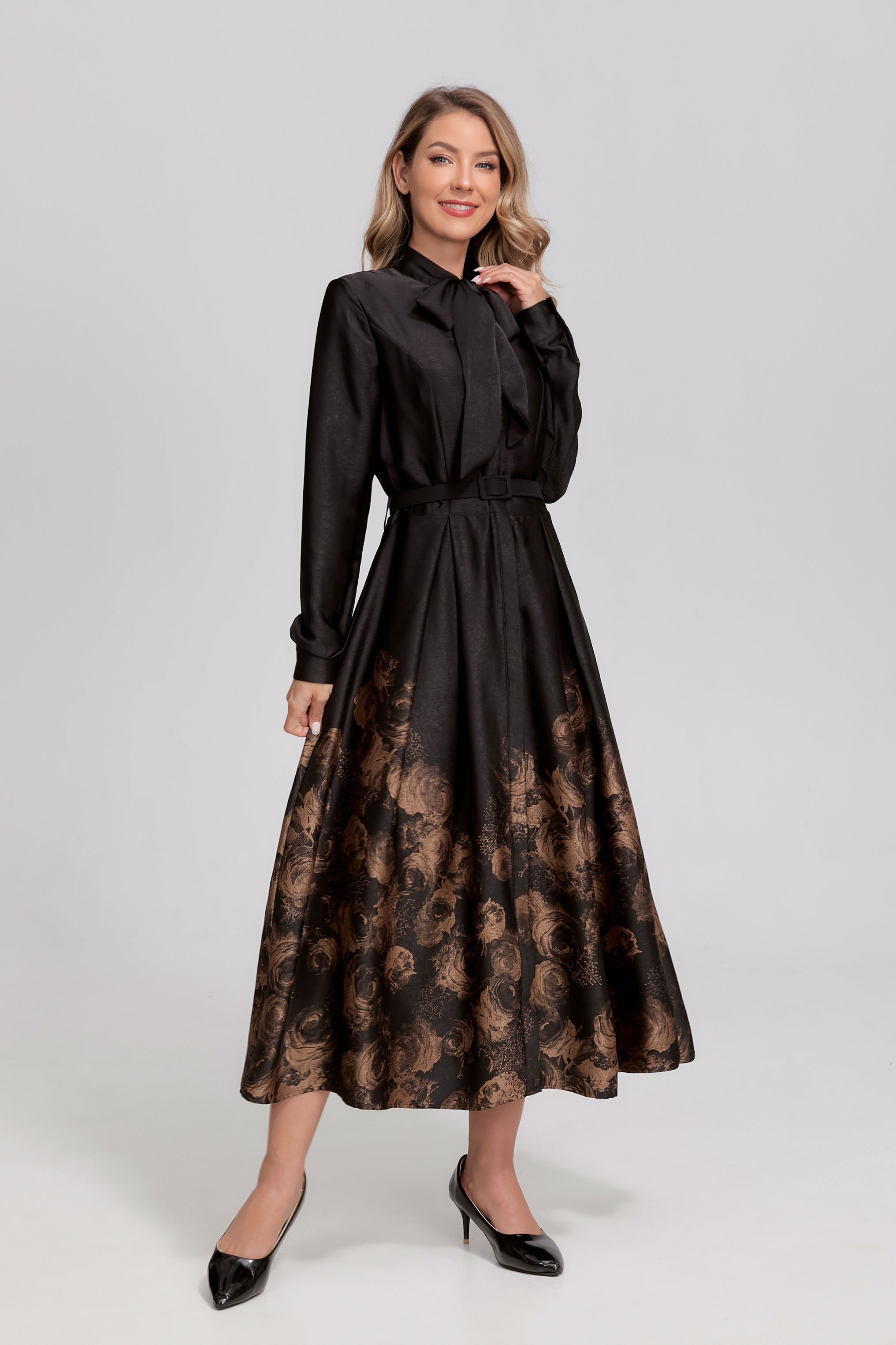 Black Noir Rosewood tie-neck midi dress by MissFinchNYC featuring a sleek silhouette and elegant gold accents.